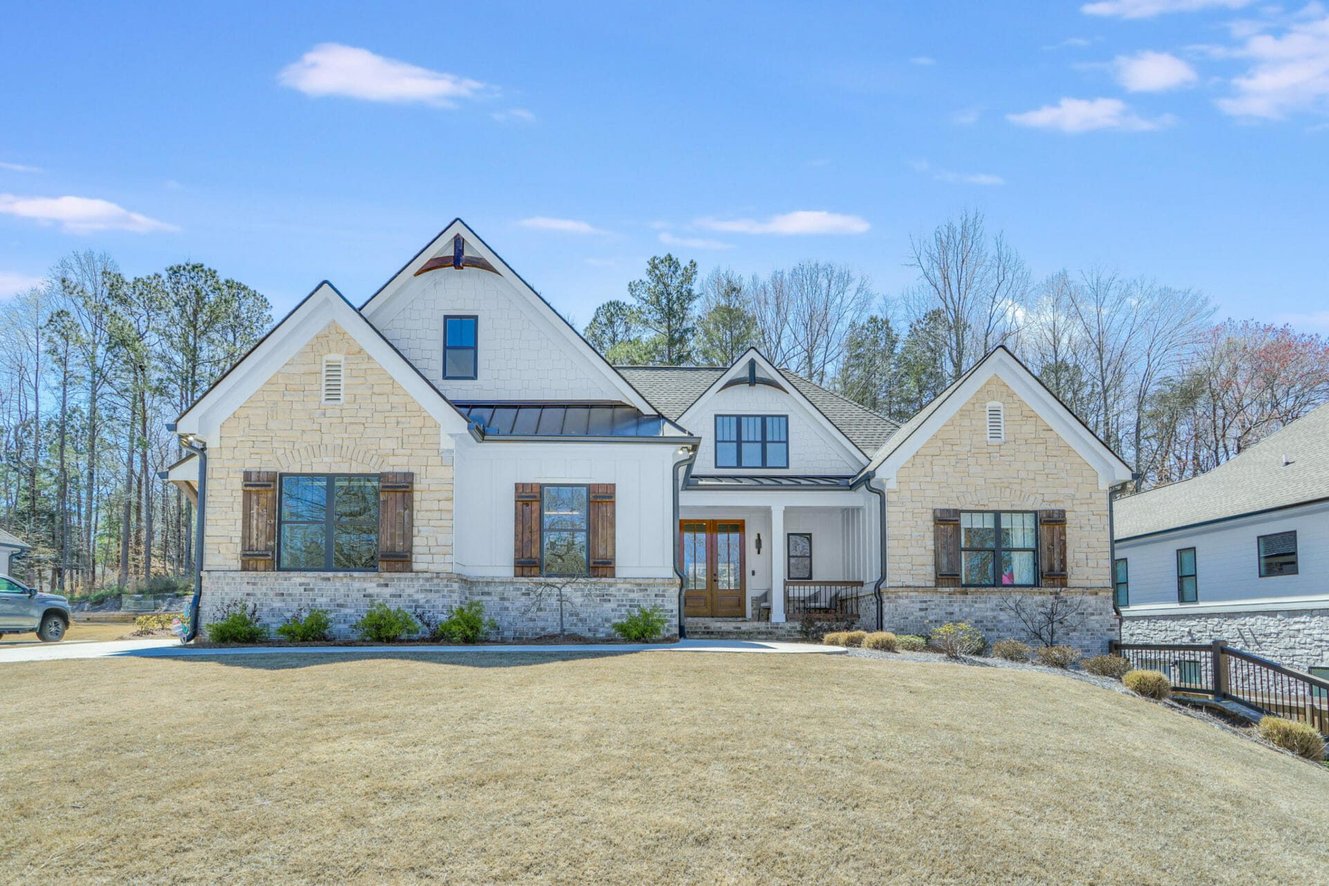 White ranch style home with stone on Lake Lanier
