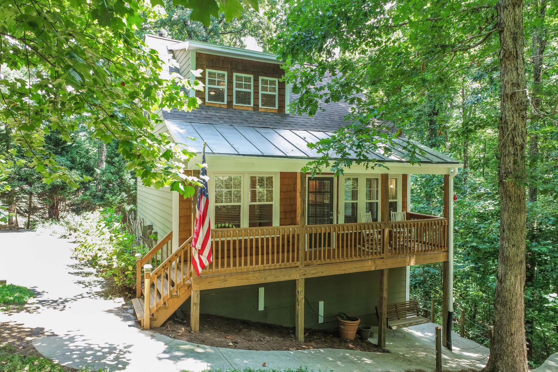 Bungalow style home with front porch in wooded area in Lake Lanier