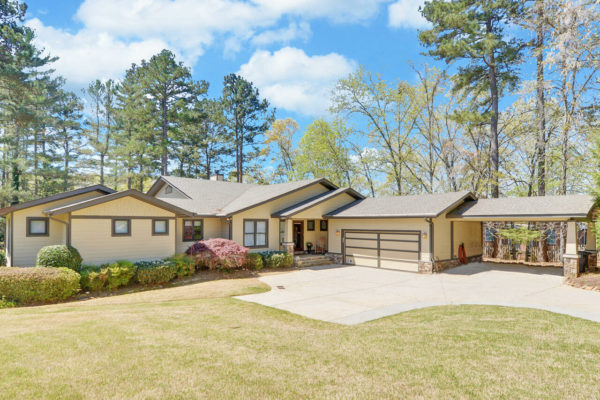 Yellow ranch style home with carport and garage in Lake Lanier